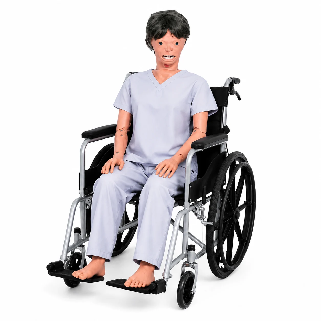 Medical training mannequin in a wheelchair wearing light-blue scrubs.