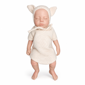 Life-like baby doll wearing a cream knitted sweater dress with a hood featuring ears, standing on a white background.