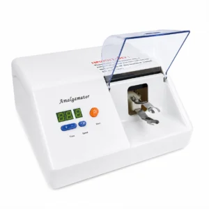 White dental amalgamator machine with a transparent lid, digital display, and blue control buttons labeled Time and Speed — Amalgamator top view on white background.