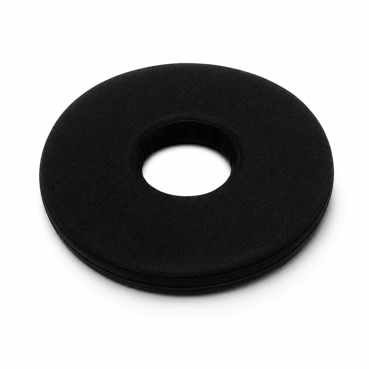 Black donut-shaped cushion with a hollow center, likely a travel neck pillow design? Noting the fabric texture and circular form.