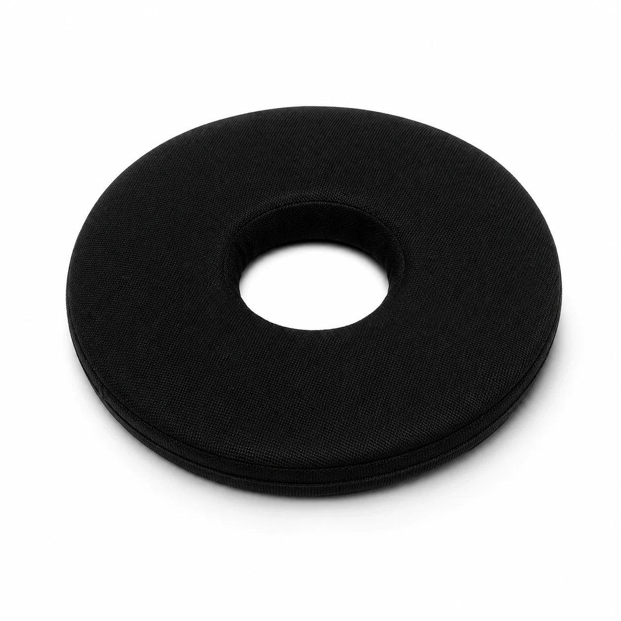 Black donut-shaped cushion with a hollow center, likely a travel neck pillow design? Noting the fabric texture and circular form.