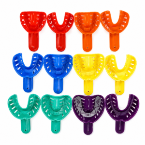 Row of colorful U-shaped dental mouth guards with handles, arranged in red, orange, blue, yellow, green and purple hues.
