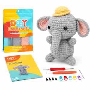 Amigurumi elephant craft kit with yarn, pattern book, tools, and crochet hook set laid out next to a gray crocheted elephant toy and a colorful bag of DIY Handicrafts materials.