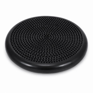 Black circular balance disc with a textured studded surface for stability training